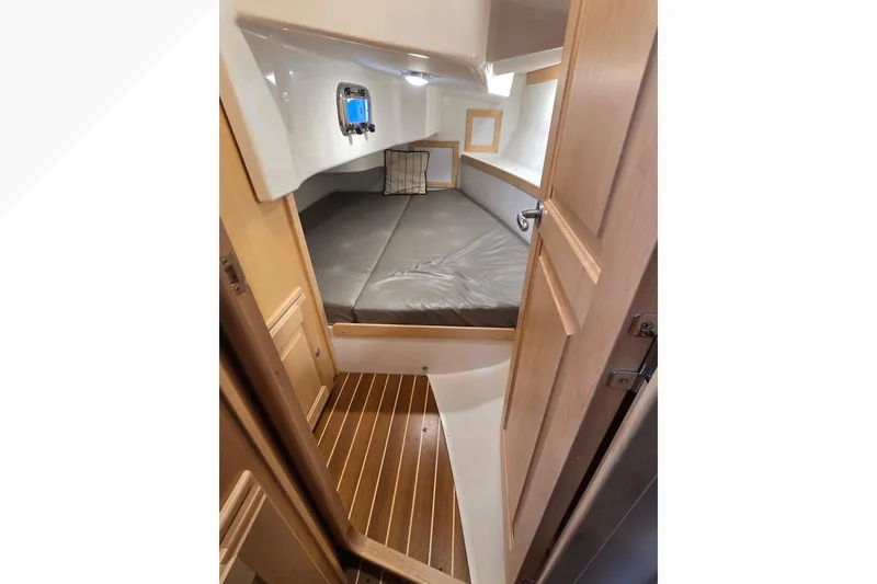 Slide: The Image of Cozy cabin interior of 2018 Tartan 345 yacht with wooden flooring and cushioned bed. - 19