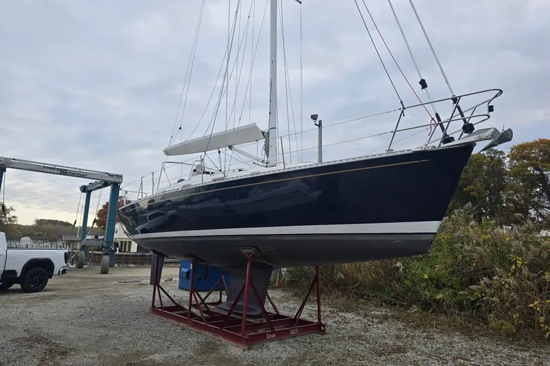 Slide: The Image of Sailboat Tartan 345, 2018 model, on a stand in a boatyard. - 2