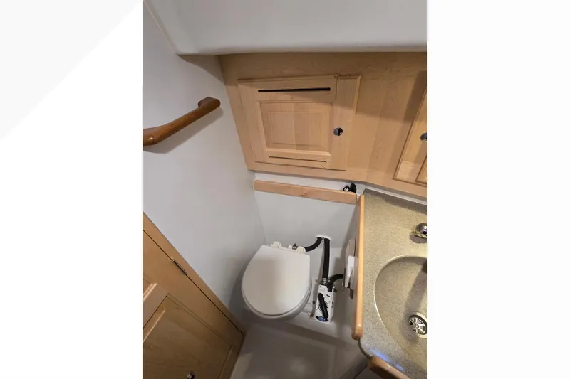 Slide: The Image of Compact bathroom in 2018 Tartan 345 yacht with wooden cabinetry and modern fixtures. - 20