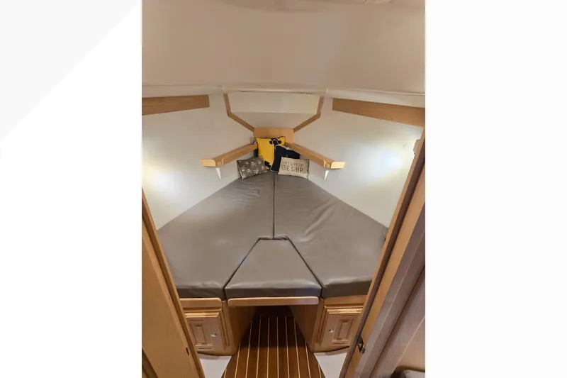 Slide: The Image of Interior cabin of 2018 Tartan 345 sailboat with cozy bedding and wooden accents. - 21
