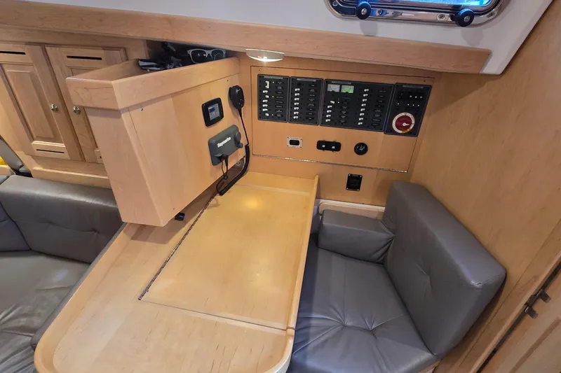 Slide: The Image of 2018 Tartan 345 yacht interior with navigation panel and seating area. - 23