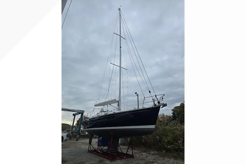 Slide: The Image of 2018 Tartan 345 sailboat on land under cloudy sky. - 3