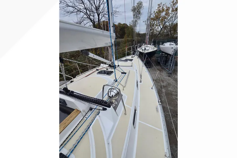 Slide: The Image of 2018 Tartan 345 sailboat on land, showcasing deck and rigging details. - 38