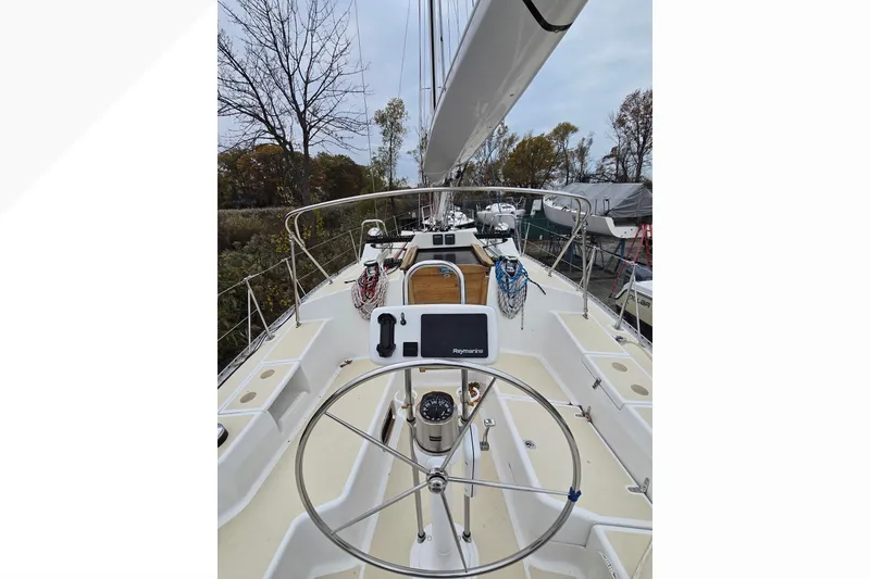 Slide: The Image of 2018 Tartan 345 sailboat cockpit with steering wheel and navigation equipment. - 45
