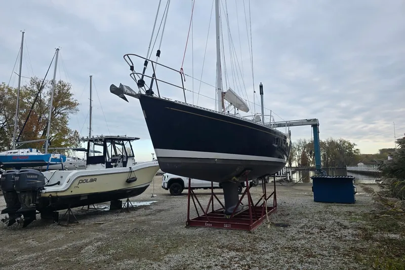 Slide: The Image of 2018 Tartan 345 sailboat on dry dock beside a motorboat, overcast sky. - 5