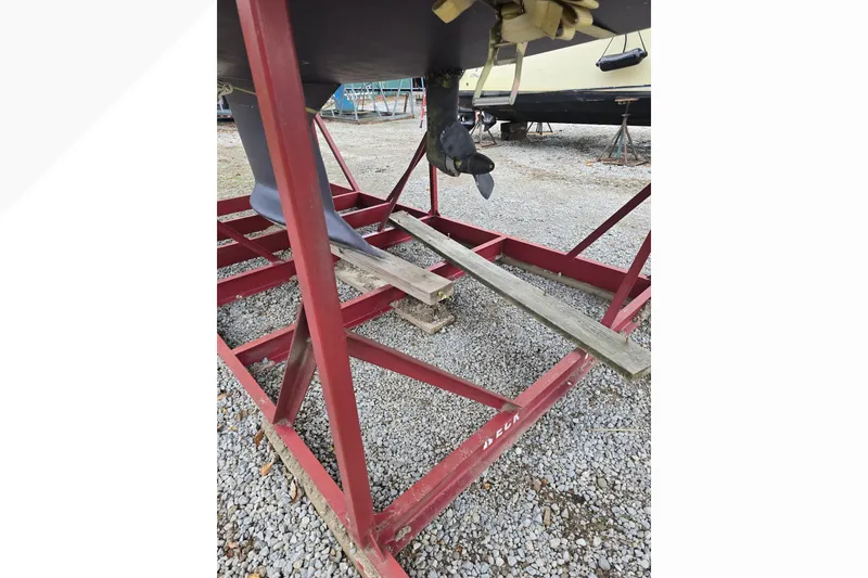 Slide: The Image of Red metal boat stand supporting a Tartan 345 sailboat, 2018 model, on gravel. - 7