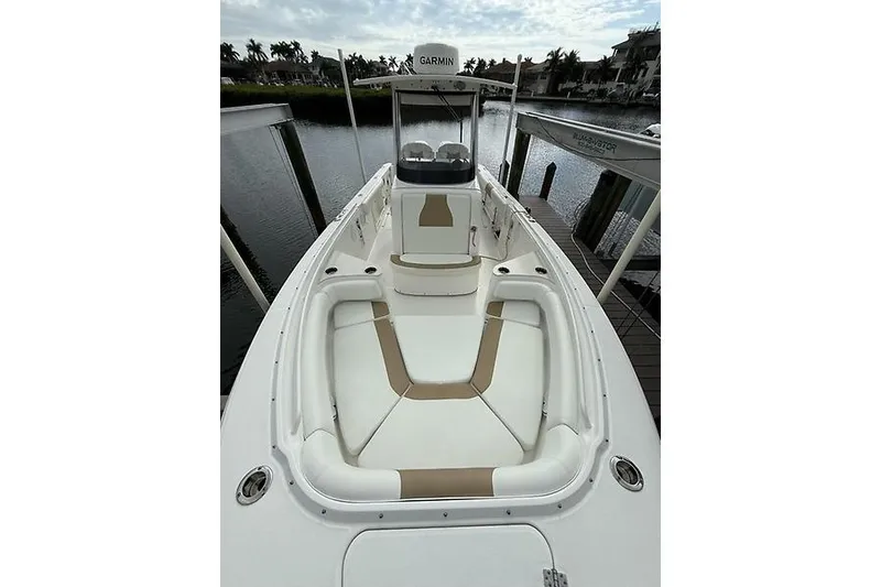 Slide: The Image of 2022 Edgewater 262CC boat with spacious seating, docked by the water. - 17