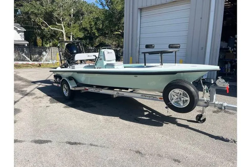 Slide: The Image of 2026 Maverick 18 HPX-V boat parked outdoors, surrounded by trees and trailers. - 3