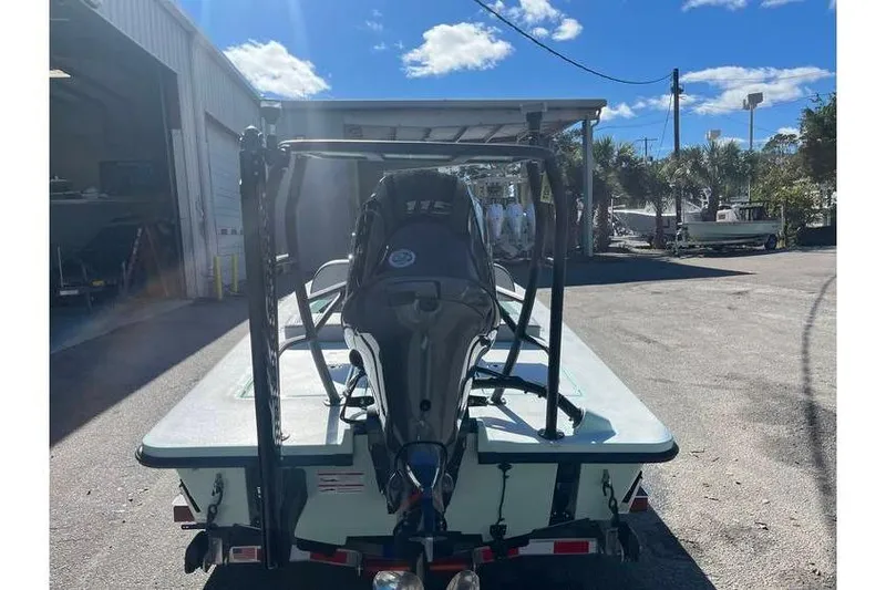 Slide: The Image of 2026 Maverick 18 HPX-V boat interior with console and seating, parked among other boats. - 6