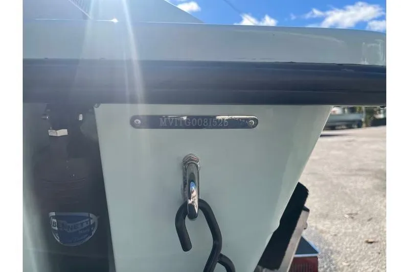 Slide: The Image of 2026 Maverick 18 HPX-V boat with outboard motor, parked outdoors under clear sky. - 7