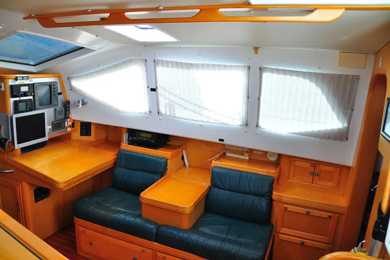 Slide: The Image of Interior of 2000 Custom Steel Cutter World Cruiser with navigation equipment and seating area. - 13