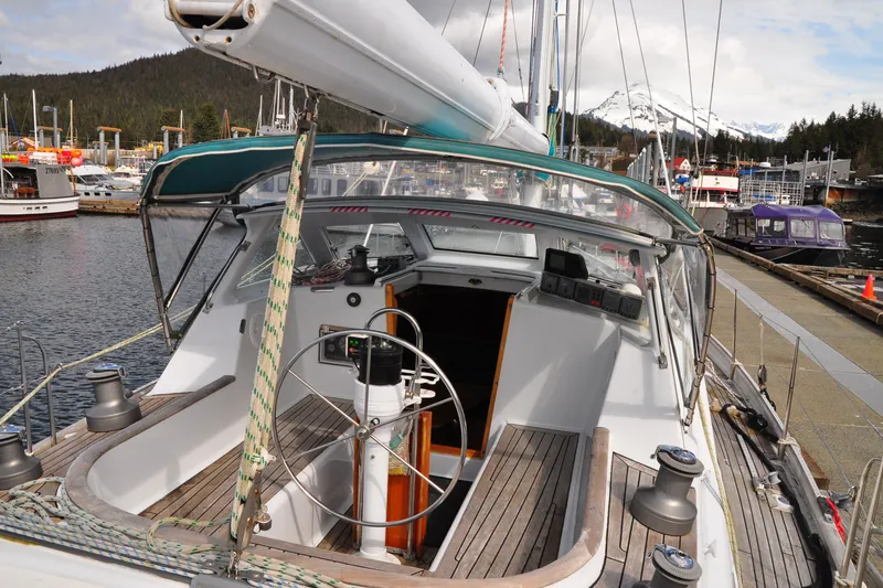 Slide: The Image of Sailboat docked at marina, Custom Steel Cutter World Cruiser, 2000 model, scenic mountain backdrop. - 25
