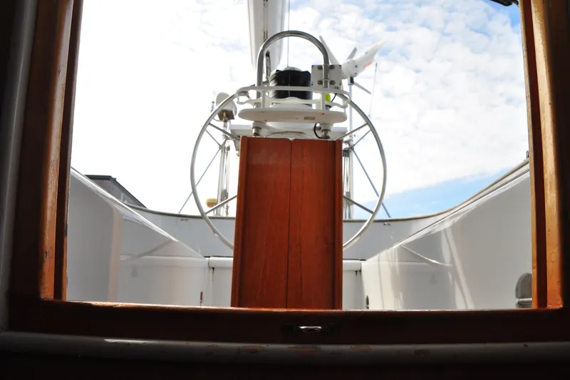 Slide: The Image of Cockpit view of 2000 Custom Steel Cutter World Cruiser sailboat under a partly cloudy sky. - 27