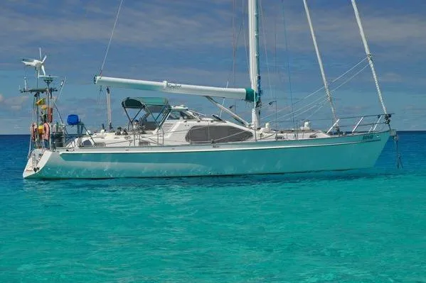 Slide: The Image of Custom Steel Cutter World Cruiser 2000 sailboat on clear turquoise water. - 3