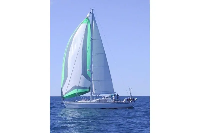 Slide: The Image of Sailing yacht "World Cruiser" by Custom Steel Cutter, 2000, with green and white sails on open sea. - 4