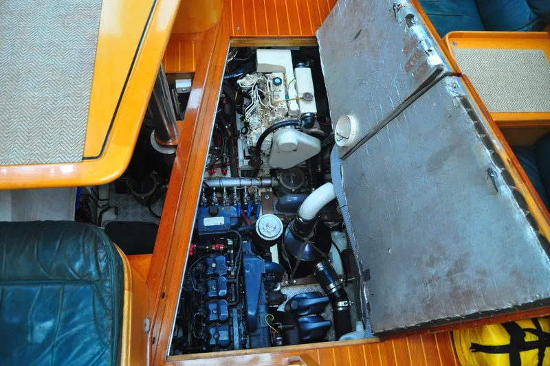 Slide: The Image of Engine compartment of a 2000 Custom Steel Cutter World Cruiser yacht, showcasing detailed machinery. - 6