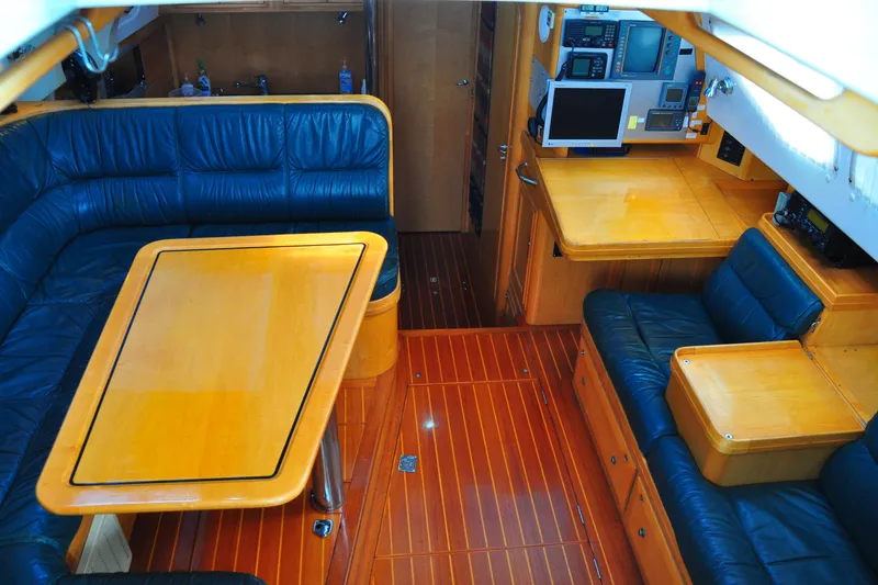 Slide: The Image of Luxurious interior of 2000 Custom Steel Cutter World Cruiser yacht with leather seating and wooden finishes. - 9