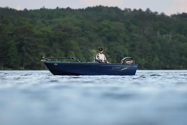 Slide: The Image of Manufacturer Provided Image: 2025 Lund 1650 Angler Tiller boat on a serene lake with forest backdrop. - 3