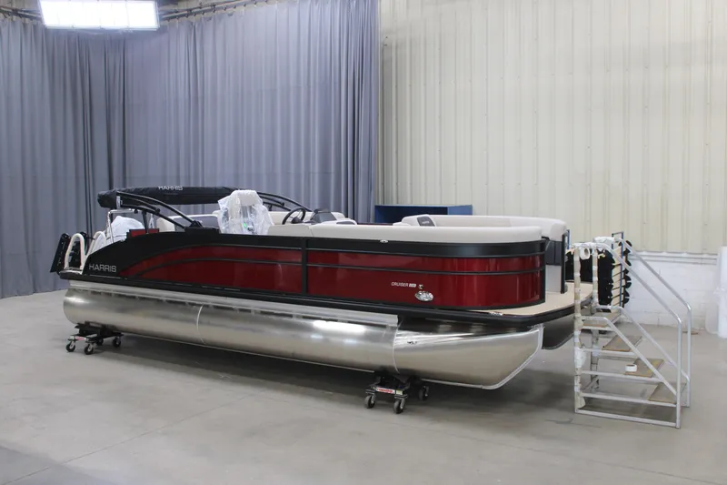 The Image of 2026 Harris Cruiser 230 pontoon boat in showroom, featuring sleek design and modern amenities. - 1
