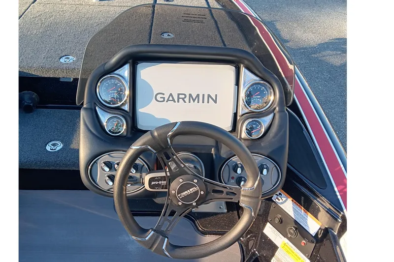 Slide: The Image of 2026 Triton 18 TrX boat dashboard with Garmin display and steering wheel. - 12