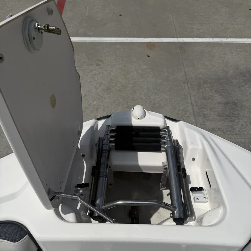 Slide: The Image of An open storage compartment on a Yamaha 212X boat reveals a folded ladder. - 22
