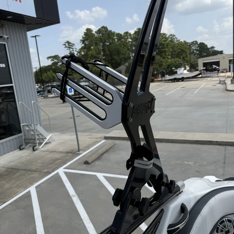 Slide: The Image of A wakeboard tower on a Yamaha 212X boat, parked in a lot. - 30