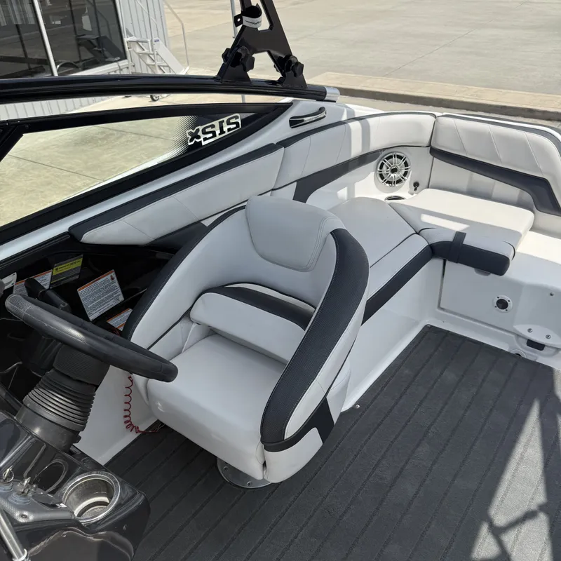 Slide: The Image of The image shows the helm of a 2014 Yamaha 212X boat with a cushioned seat. - 15