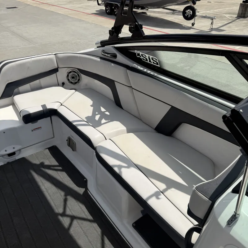 Slide: The Image of The image shows the cockpit of a 2014 Yamaha 212X boat with white upholstery. - 14