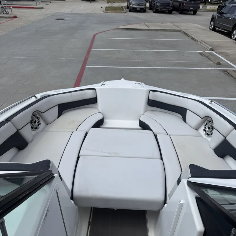 Slide: The Image of The image shows the bow of a Yamaha 212X boat with white and black upholstery. - 20