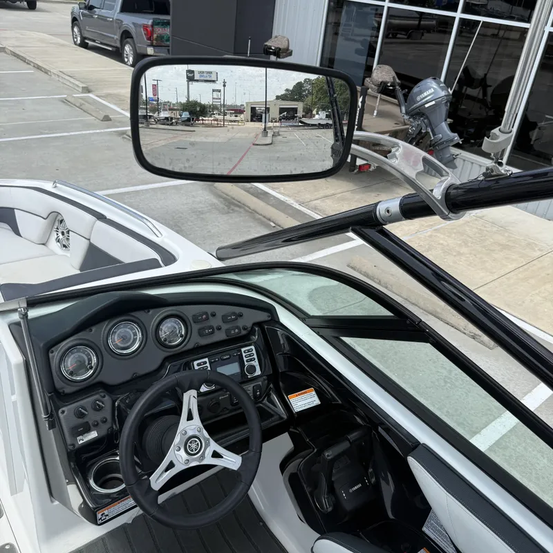 Slide: The Image of The image shows the cockpit of a 2014 Yamaha 212X boat with a modern dashboard. - 16