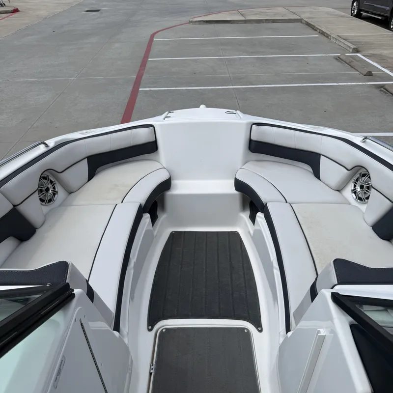 Slide: The Image of The image shows the bow area of a 2014 Yamaha 212X boat with cushioned seating. - 21
