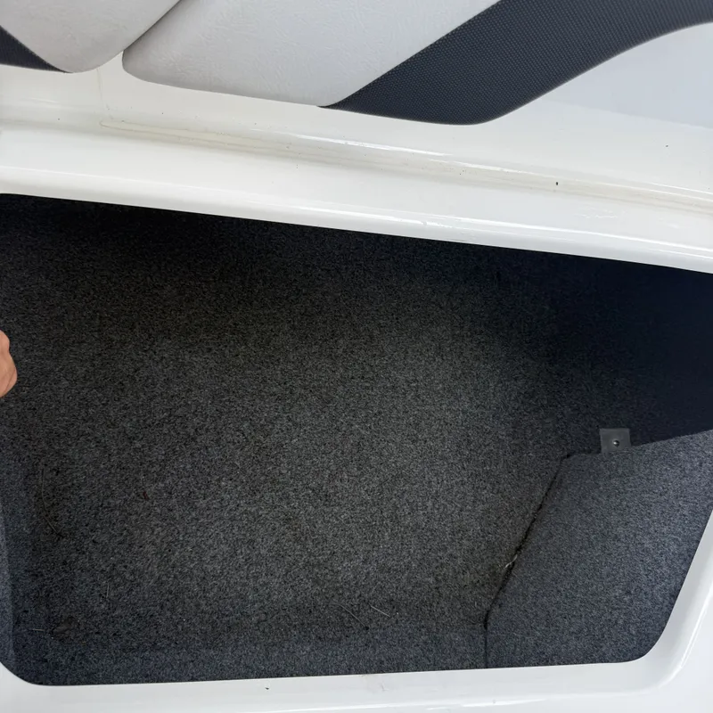 Slide: The Image of An empty, carpeted storage compartment inside a boat. - 26