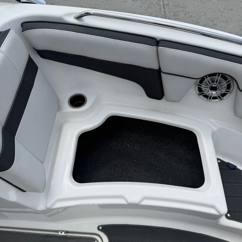 Slide: The Image of The image shows the seating area of a Yamaha 212X boat with a speaker and storage space. - 23