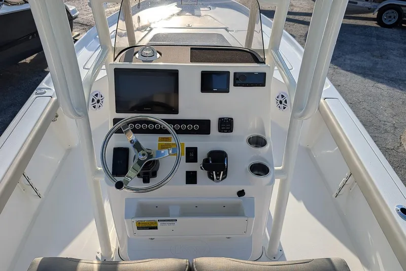 Slide: The Image of 2026 Key West 250 Bay Reef boat console with steering wheel and navigation display. - 13