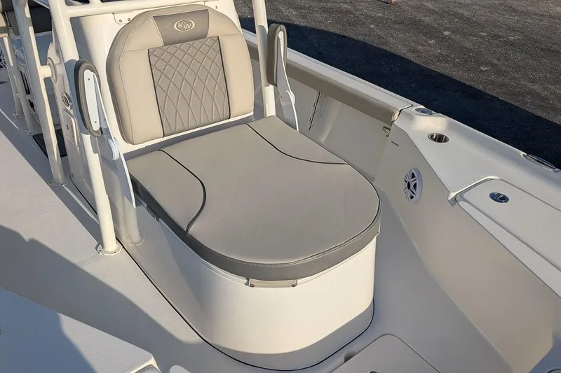 Slide: The Image of 2026 Key West 250 Bay Reef boat seat with cushioned backrest and storage. - 15