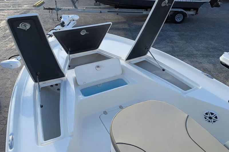 Slide: The Image of 2026 Key West 250 Bay Reef boat with open storage compartments and seating area. - 18
