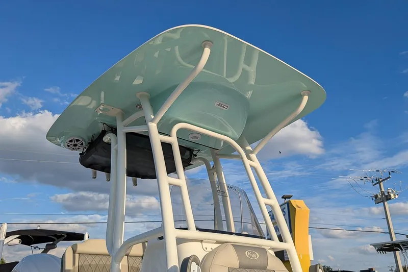Slide: The Image of 2026 Key West 250 Bay Reef boat with T-top against blue sky. - 21