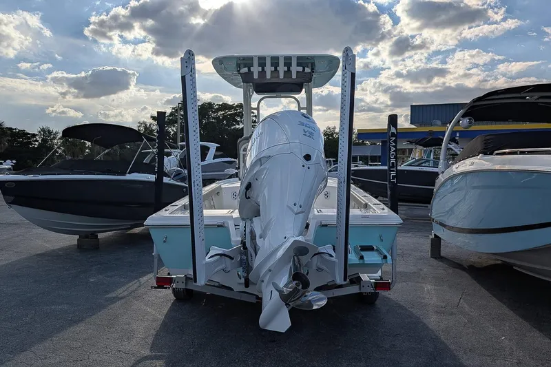 Slide: The Image of 2026 Key West 250 Bay Reef boat on trailer under cloudy sky. - 3