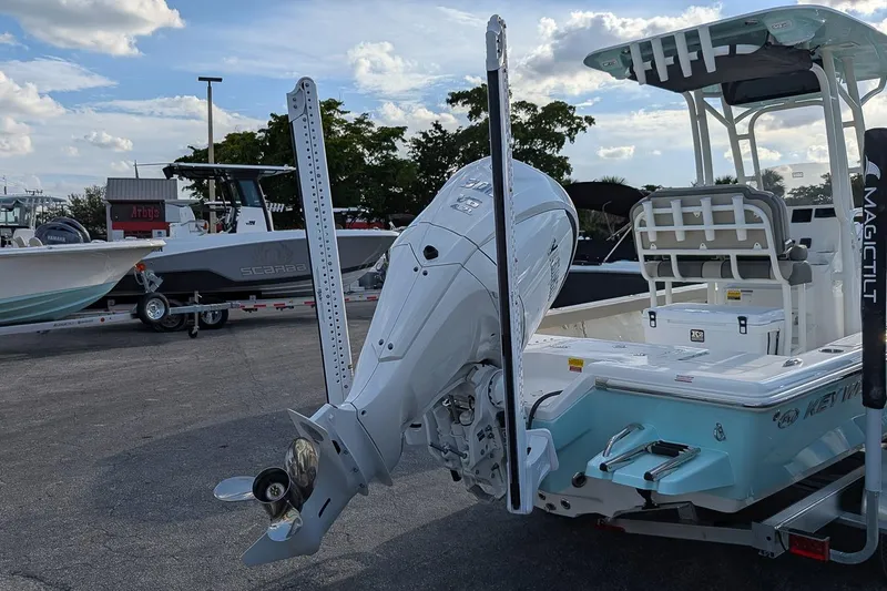 Slide: The Image of 2026 Key West 250 Bay Reef boat with outboard motor in a parking lot. - 4