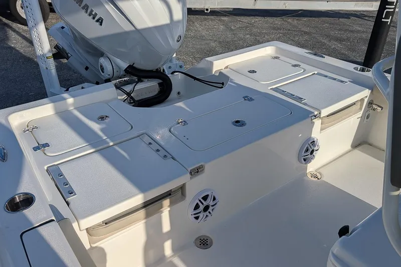 Slide: The Image of 2026 Key West 250 Bay Reef boat interior with Yamaha engine, featuring storage compartments and speakers. - 7