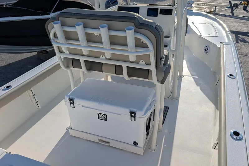Slide: The Image of 2026 Key West 250 Bay Reef boat interior with seating and cooler. - 9