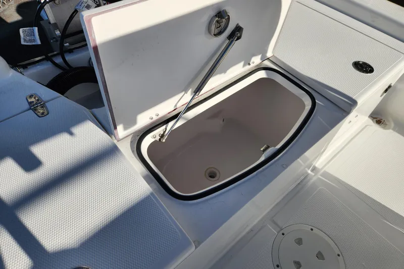 Slide: The Image of Open storage compartment on 2026 BlackJack 224 boat, showcasing interior design and functionality. - 10