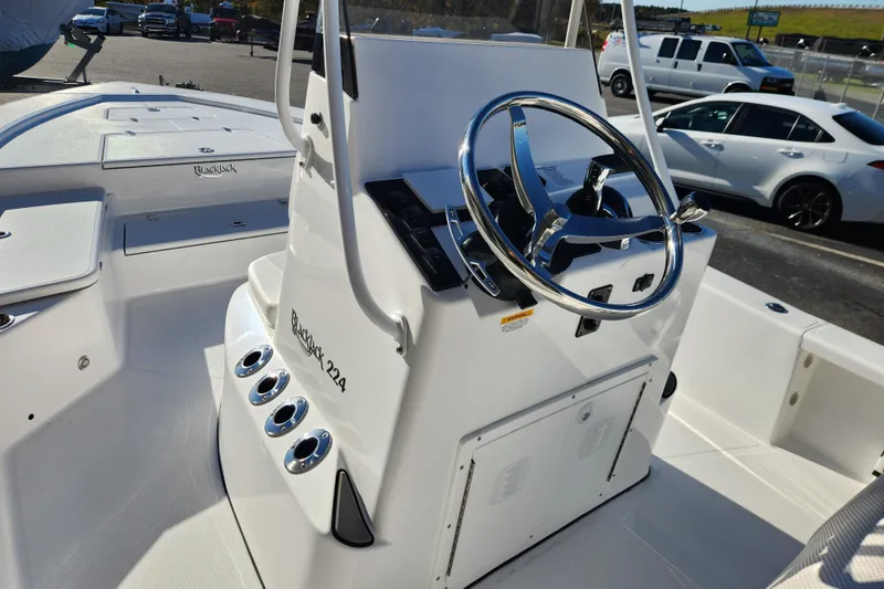 Slide: The Image of Steering console of a 2026 BlackJack 224 boat, featuring a sleek design and chrome accents. - 15