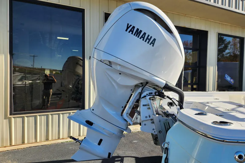 Slide: The Image of Yamaha outboard motor on BlackJack 224 boat, 2026 model, outside a building. - 3