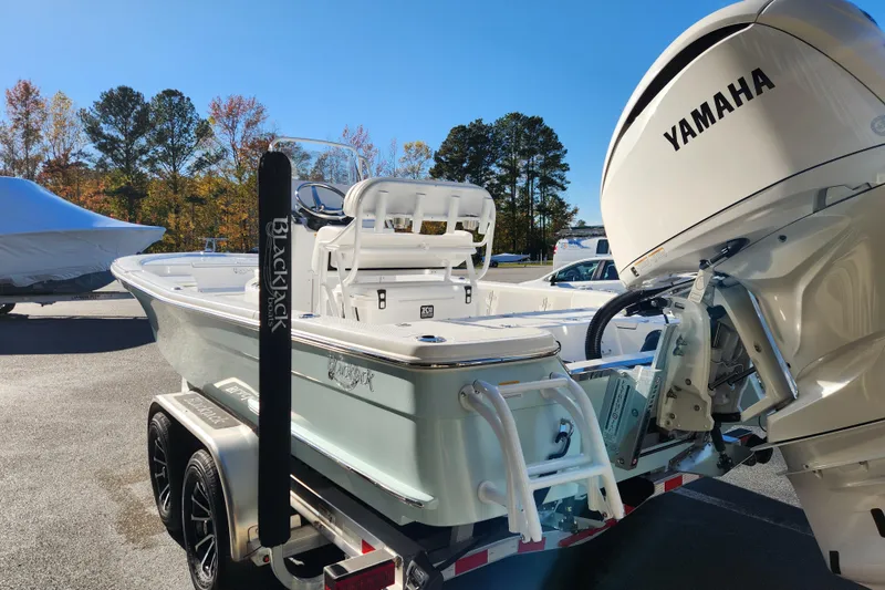 Slide: The Image of 2026 BlackJack 224 boat with Yamaha engine on trailer, outdoor setting. - 5