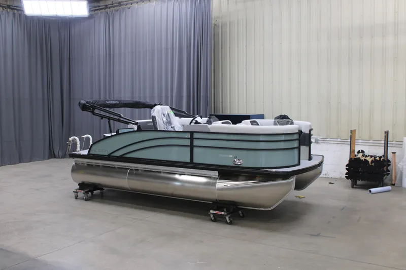 The Image of 2026 Harris Cruiser 190 pontoon boat in a warehouse setting. - 1