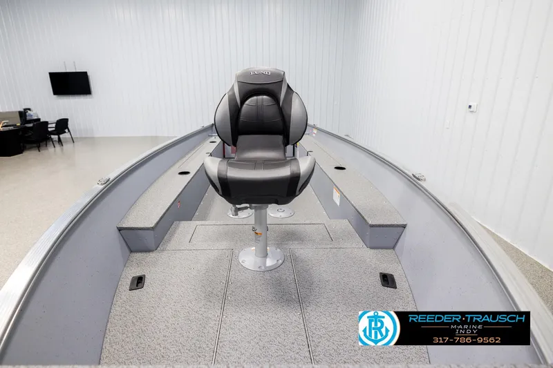 Slide: The Image of 2026 Lund 1600 Fury Tiller boat interior with a central seat in a showroom. - 15