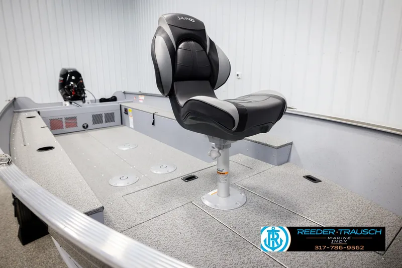 Slide: The Image of 2026 Lund 1600 Fury Tiller boat interior with swivel seat and motor, displayed at Reeder Trausch Marine. - 18