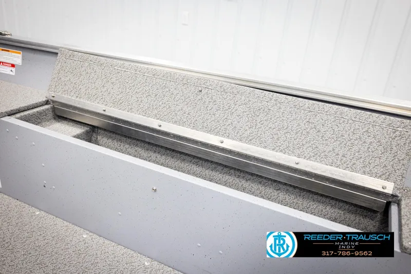 Slide: The Image of 2026 Lund 1600 Fury Tiller boat interior with storage compartment, Reeder-Trausch Marine logo. - 21