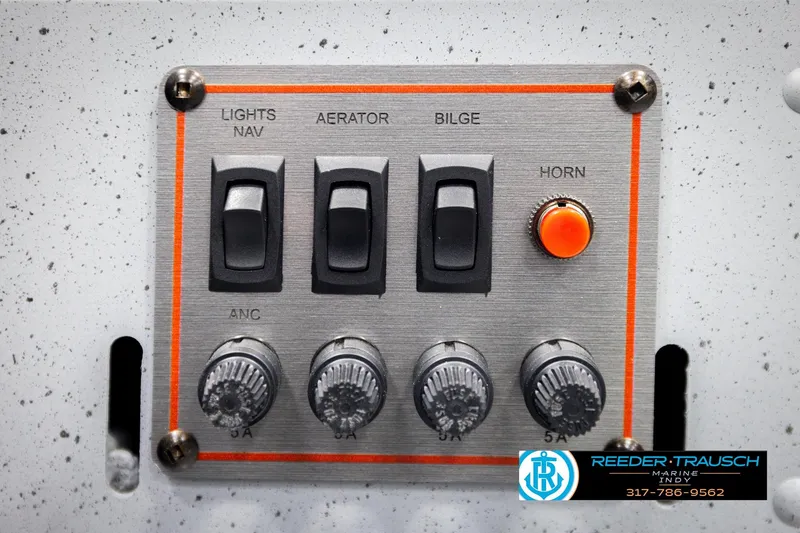 Slide: The Image of Control panel of 2026 Lund 1600 Fury Tiller boat with switches and knobs. - 26